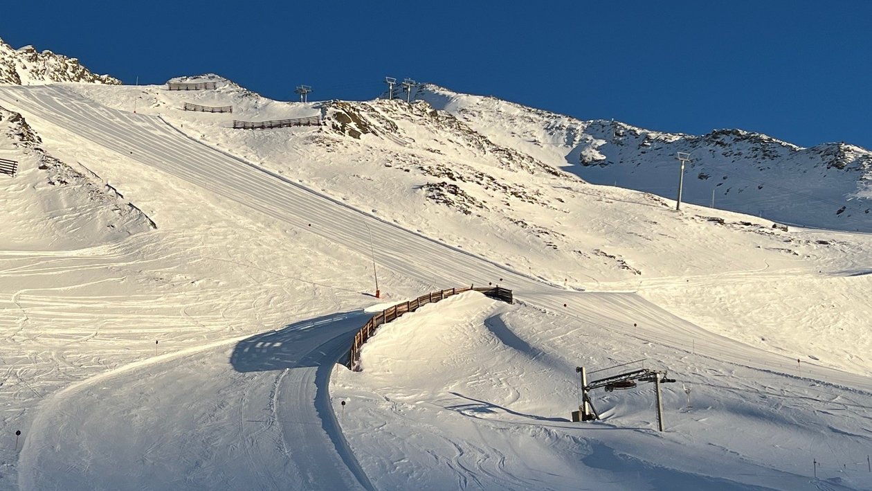 Traumhafte Pisten im Ötztal Skigebiet mit schneebedeckten Abfahrten und Bergpanorama unter blauem Himmel, geeignet für Wintersportler.